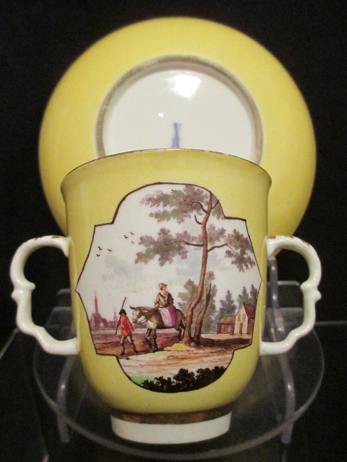 Meissen Yellow Ground Scenic Beaker and Saucer. Dating between 1735 - 1740.