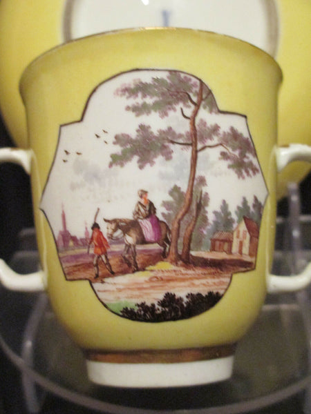 Meissen Yellow Ground Scenic Beaker and Saucer. Dating between 1735 - 1740.