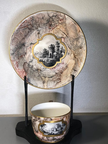 A Frankenthal porcelain marbled ground teacup and saucer, c.1783
