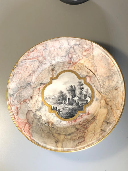A Frankenthal porcelain marbled ground teacup and saucer, c.1783